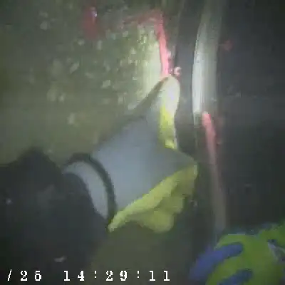 A gloved hand showing where sealant has been applied