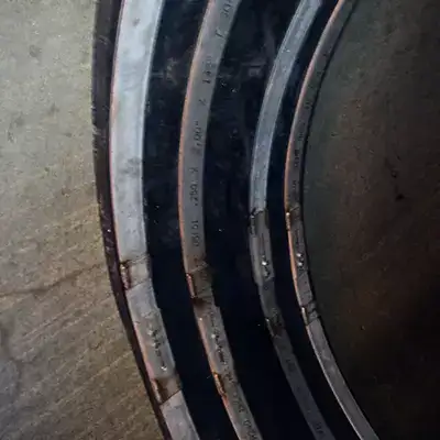 A HydraTite seal installed in a pipe with four steel retaining bands