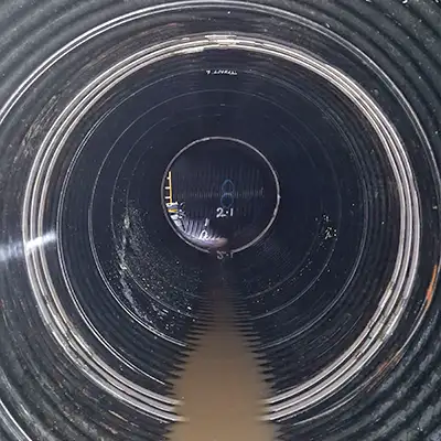 Two joints in a corrugated pipe that have been repaired using HydraTite