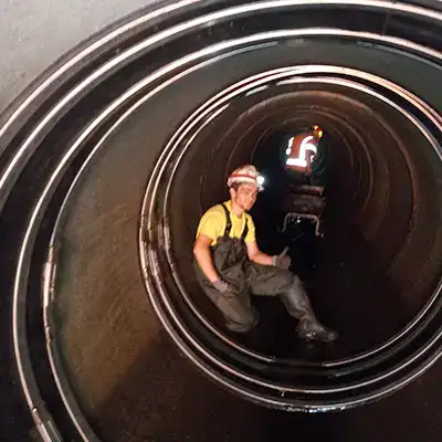 A technician sitting a pipe that has been sealed with the HydraTite seal