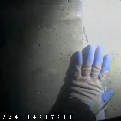 A hand pointing out a joint in a box culvert