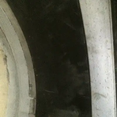 A HydraTite seal installed over a joint in a pipe with concrete rounding out the lip of the seal