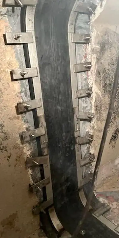 A side of a box-shaped flume that has a HydraTite seal covering a joint