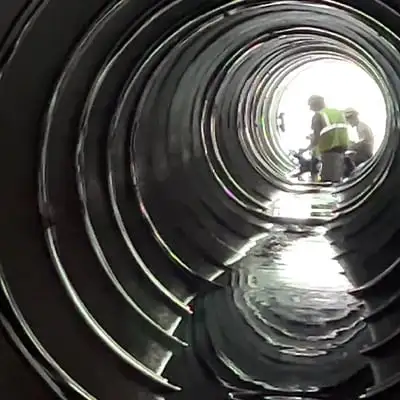 two technicians installing HydraTite in a stormwater culvert