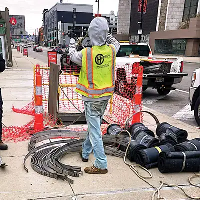 Technicians preparing to enter a pipe with all the HydraTite materials to repair the pipe joints below the road
