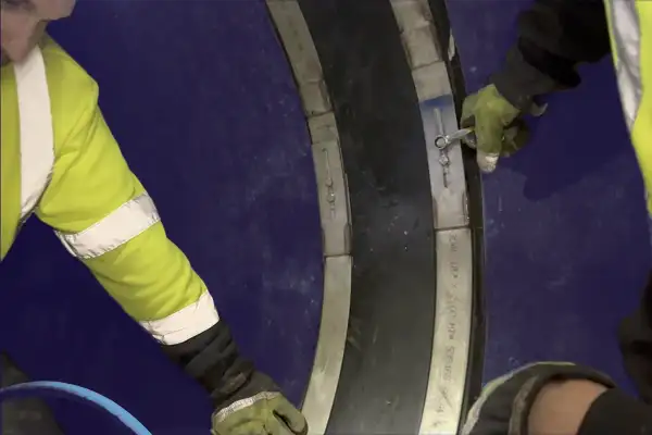 Technicians tightening bolts in a HydraTite seal installation