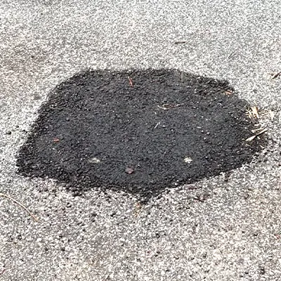 A small patch of concrete in a road