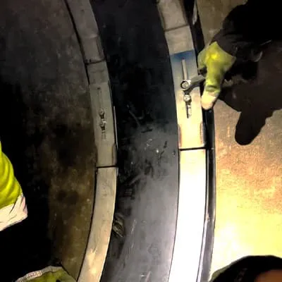 HydraTite being installed by technicians tightening bolts