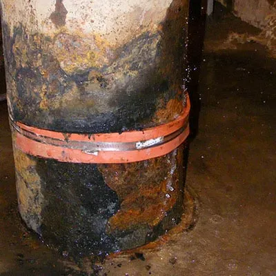 A clamp stopping a leak in an ash sluice pump intake manifolds