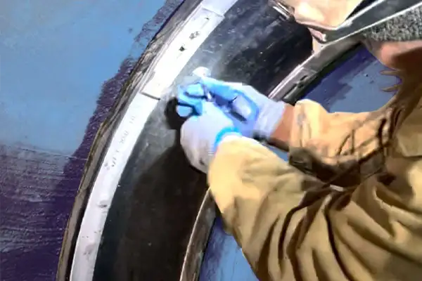 A technician opening an air port on a HydraTite seal to test the installation and ensure a watertight joint