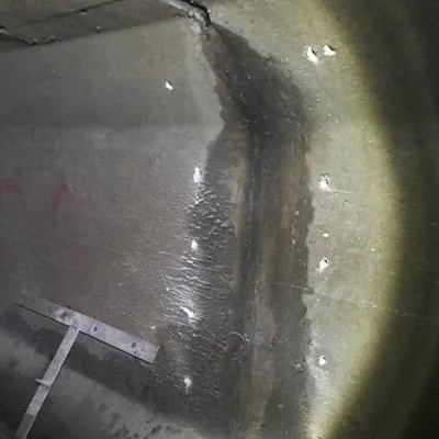 Holes drilled on either side of a pipe joint in a box-shaped pipe