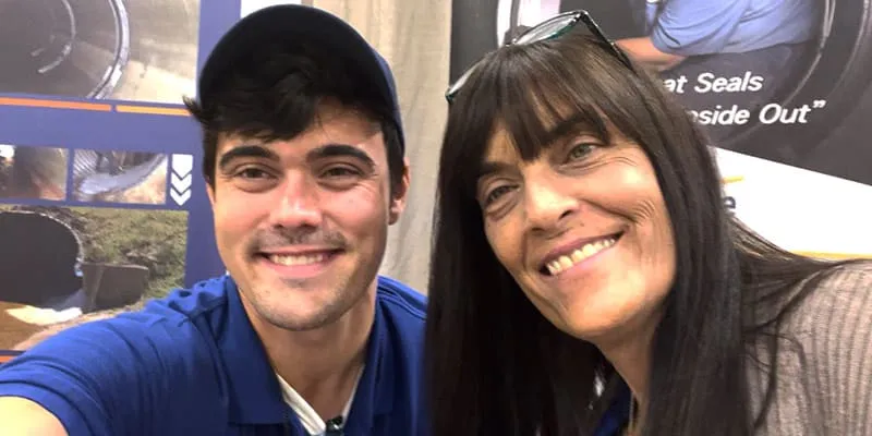Caleb and Jennifer sitting at the OTEC booth