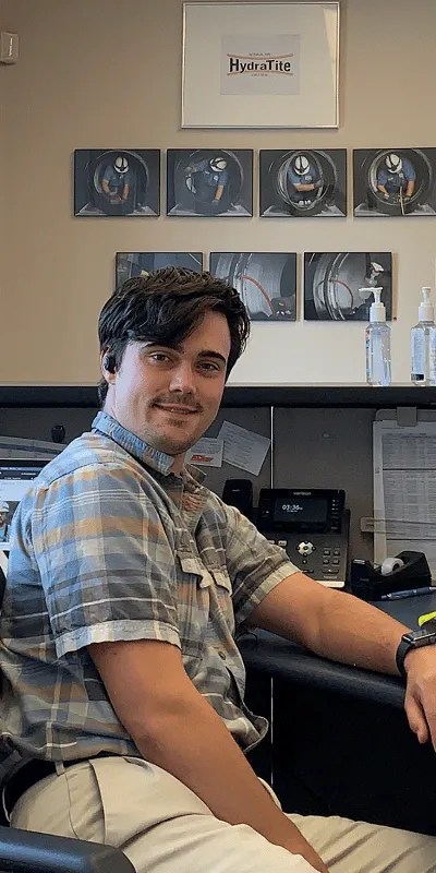 Caleb sitting at the front desk in HydraTech's Cincinnati location