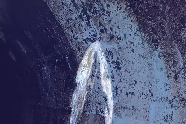 Water pouring into a pipe