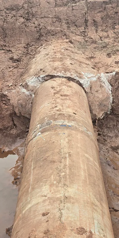 A pipe that has been partially dug up so a defect could be found and repaired