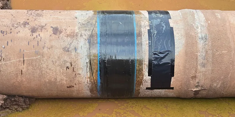 HydraWrap applied to the exterior of a partially unearthed pipe