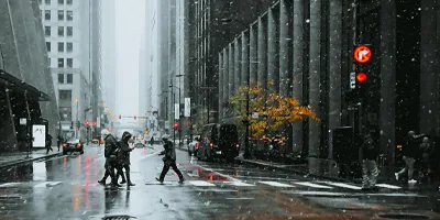 People walking across a cross-walk in a city while it is a raining