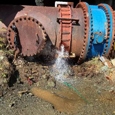 An external view of an expansion joint in a penstock pipeline that is leaking