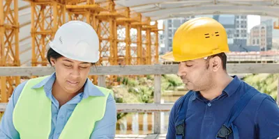 Two people looking at plans